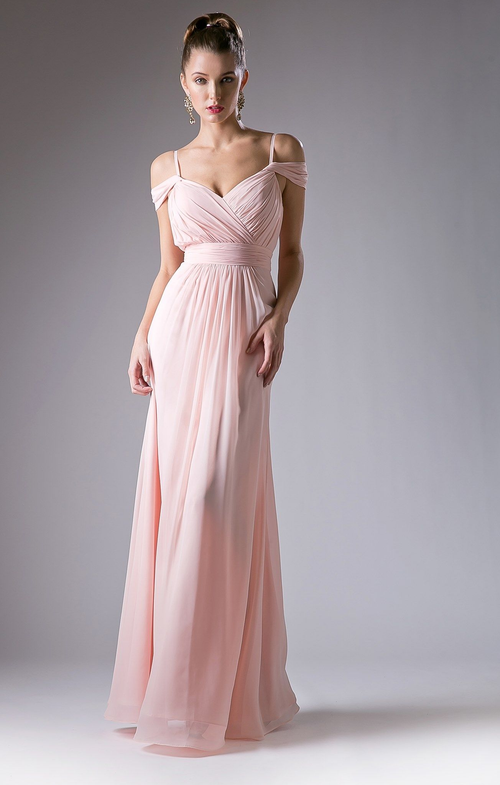 Woman wearing a pink evening gown against a gray background
